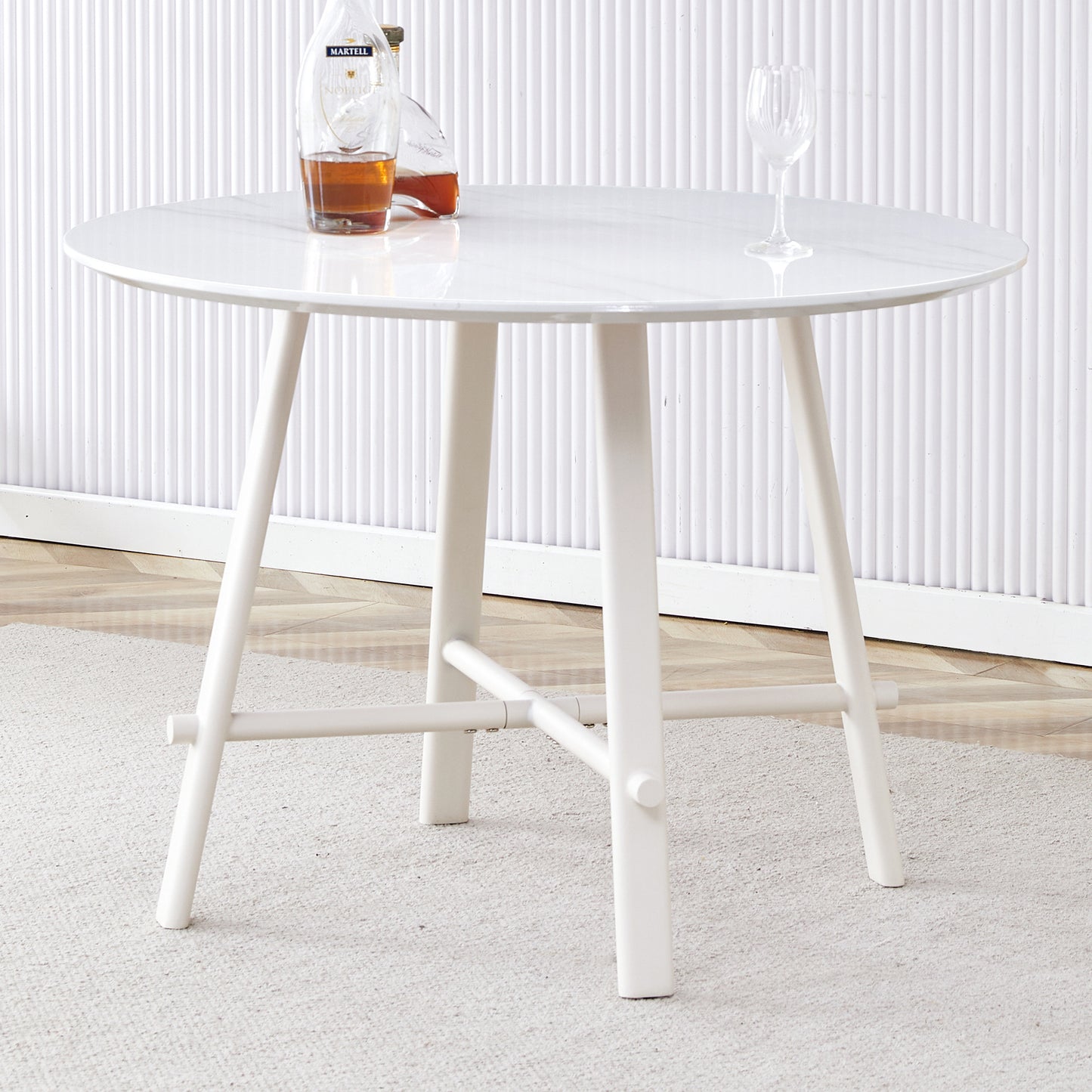 A modern minimalist circular dining table with a 42 inch diameter white patterned tabletop and white metal legs. Suitable for restaurants, living rooms, and conference rooms.