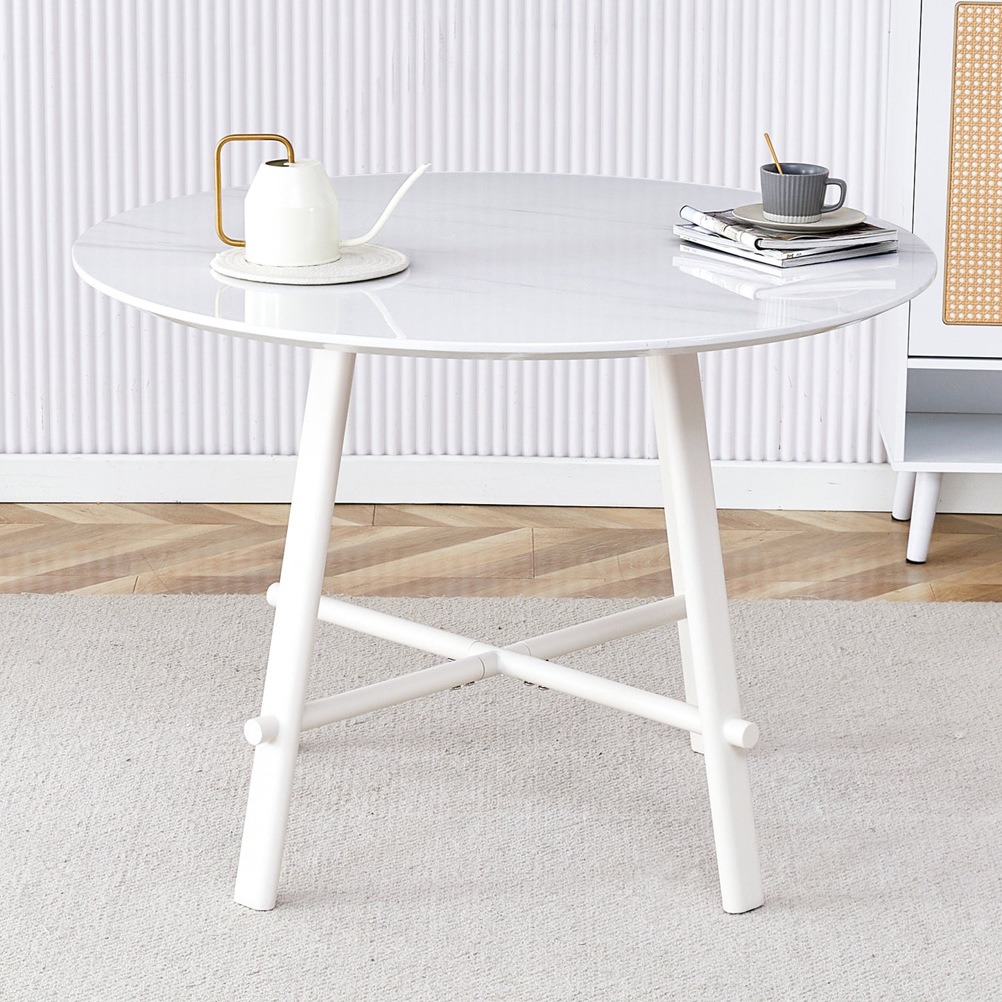 A modern minimalist circular dining table with a 42 inch diameter white patterned tabletop and white metal legs. Suitable for restaurants, living rooms, and conference rooms.