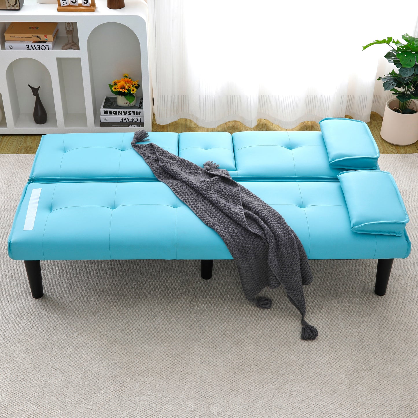 The 67-inch blue PVC multi-functional sofa bed, with a foldable and cup holder design, makes it extremely convenient to turn the living room into a guest room
