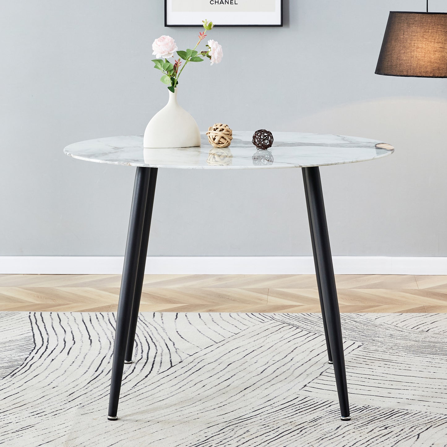 A modern minimalist circular dining table with a diameter of 40 inches, a 0.3 inch thick imitation marble pattern tabletop and black metal legs  40 '* 40' * 30 'DT-1164