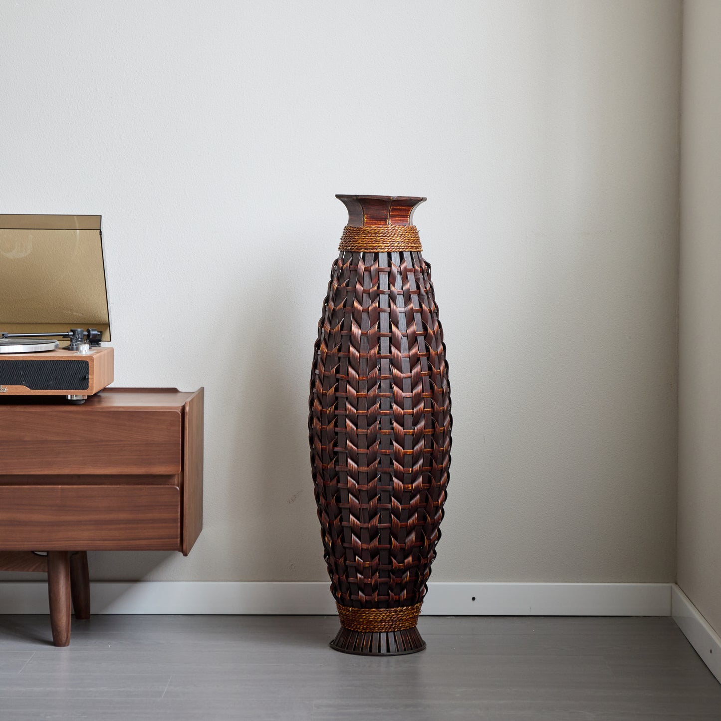 A 39-inch tall hand-woven bamboo floor vase - a decorative highlight for the living room, foyer or corridor - a versatile home decor item suitable for dried or silk flower arrangements.