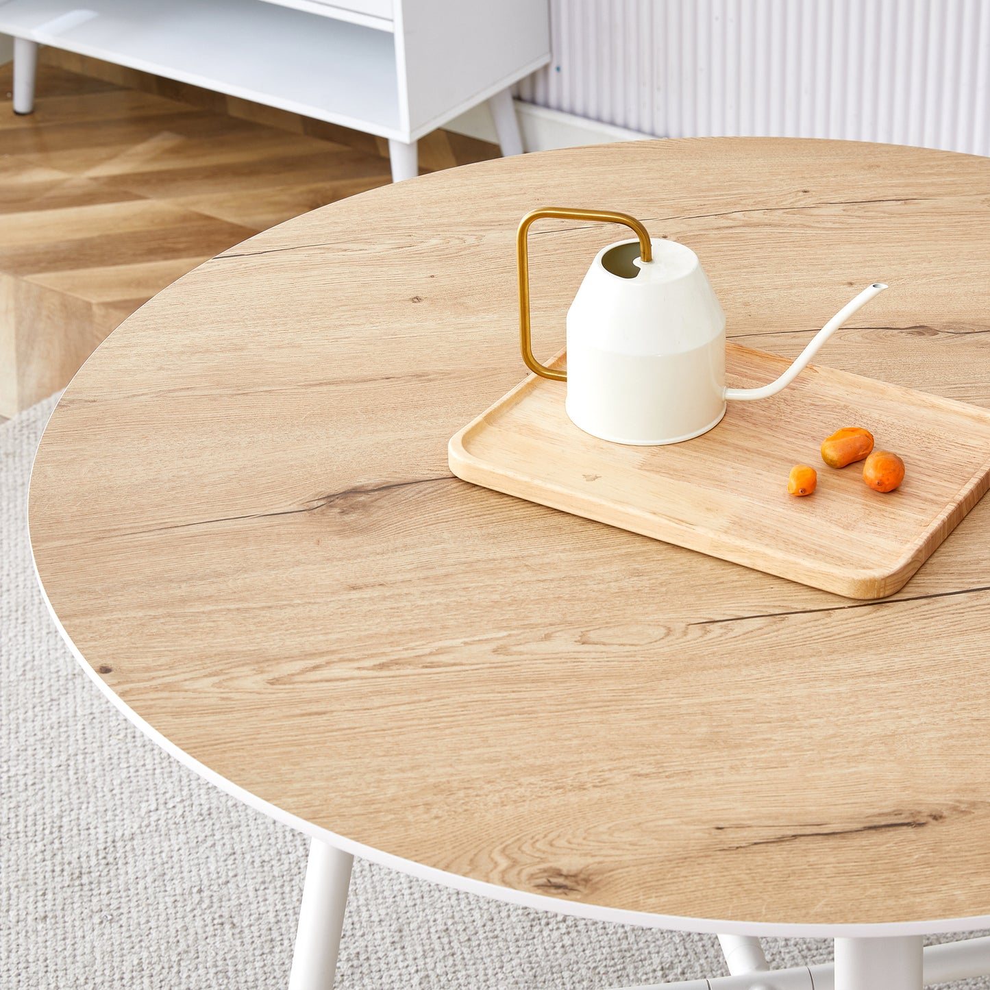 A modern and minimalist circular dining table with a 42 inch diameter wood colorer patterned tabletop and white metal legs. Suitable for restaurants, living rooms, and conference rooms.