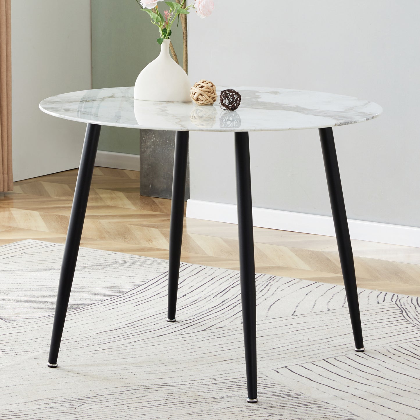 A modern minimalist circular dining table with a diameter of 40 inches, a 0.3 inch thick imitation marble pattern tabletop and black metal legs  40 '* 40' * 30 'DT-1164