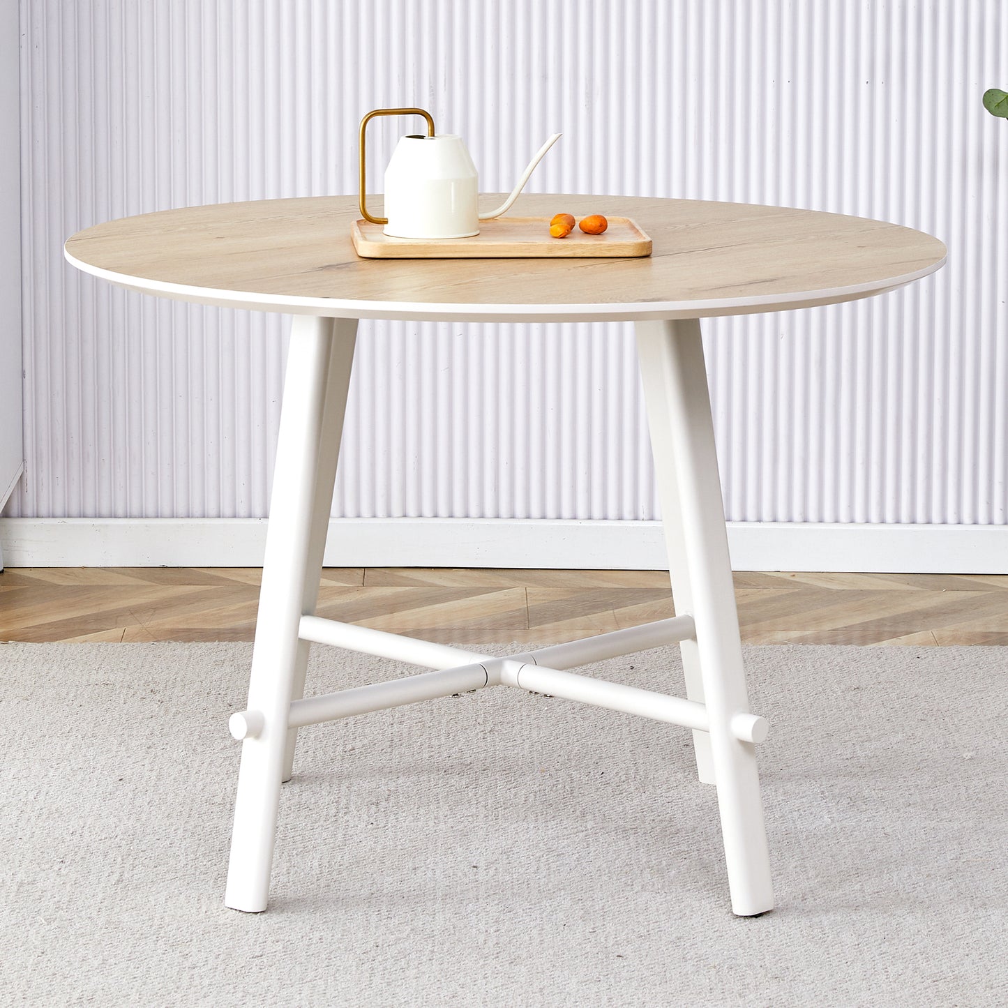 A modern and minimalist circular dining table with a 42 inch diameter wood colorer patterned tabletop and white metal legs. Suitable for restaurants, living rooms, and conference rooms.