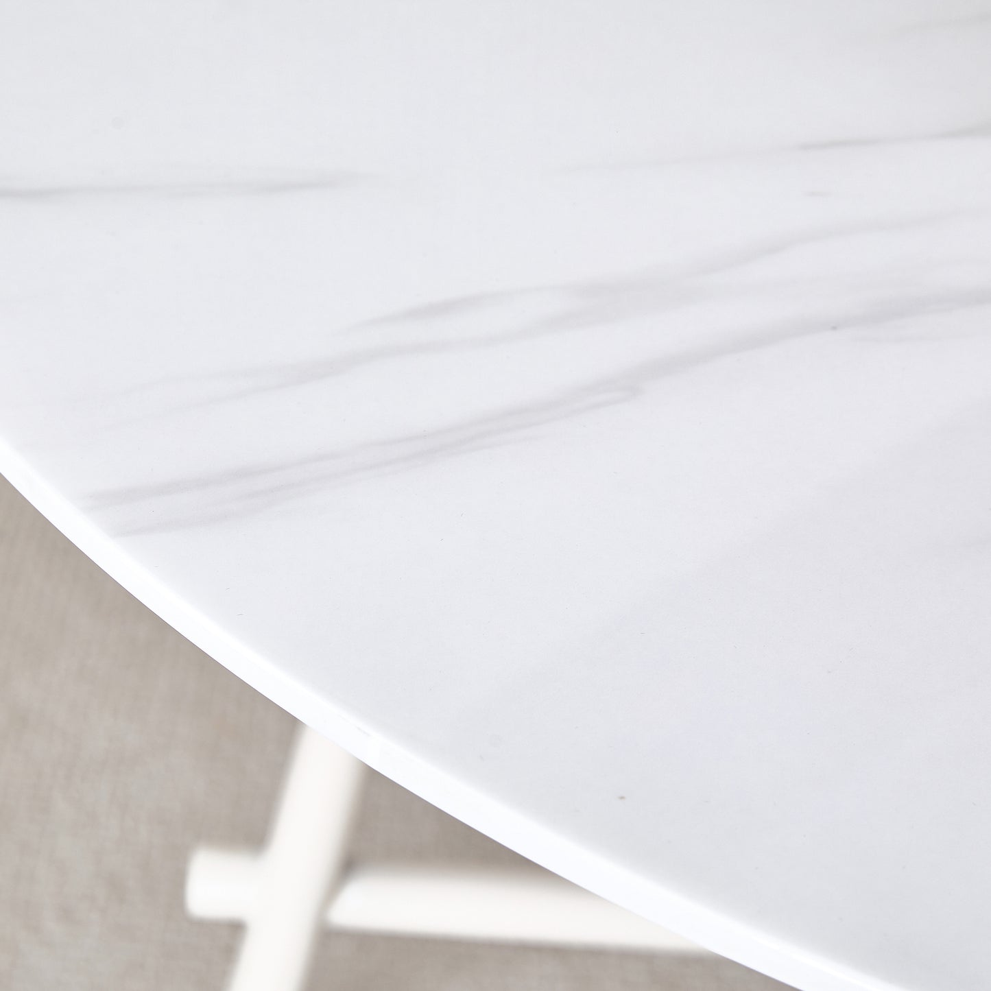 A modern minimalist circular dining table with a 42 inch diameter white patterned tabletop and white metal legs. Suitable for restaurants, living rooms, and conference rooms.